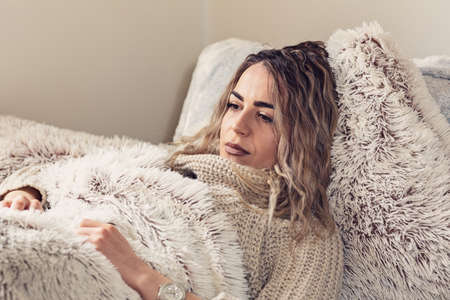 Lazy morning. beautiful woman relaxing in bedroom at homeの写真素材