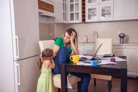 Family budget and finances- young mother with daughter planning home budgetの写真素材