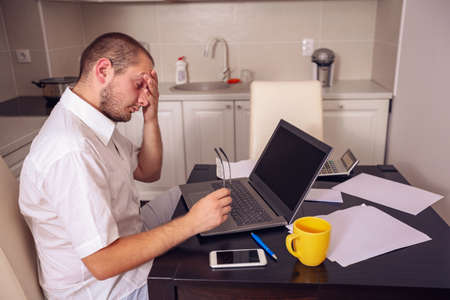 unhappy young freelancer man working from home