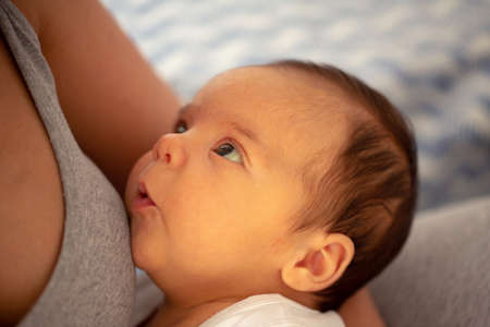 Portrait of beautiful baby boy with blue eyes in motherâ€™s arms - child, happiness and...