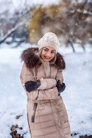 wintertime- Smiling young girl in a white winter forest