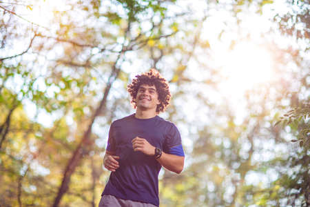 Young fitness Man running at the nature- fitness, sport, training and lifestyle conceptの写真素材