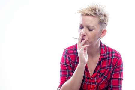 young woman smoking cigarette. No smoking and nicotine addiction problem concept.の写真素材