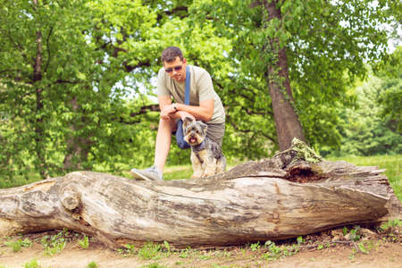 Smiling Man with cute dog enjoying in parkの写真素材