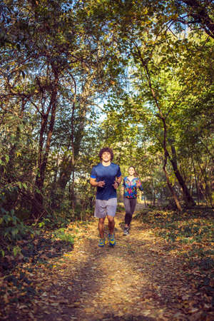 Cardio exercise - smiling couple running or joggingの写真素材