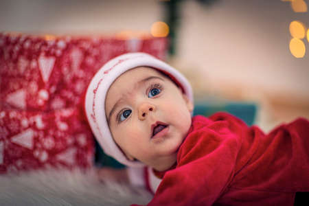 lovely baby in santa claus costume in Christmas room on Christmas day.の写真素材