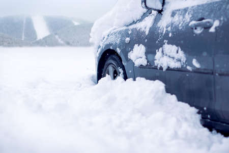 
Snow covered car on a cold winter day.Frozen car covered snow at winter day, backgroundの写真素材