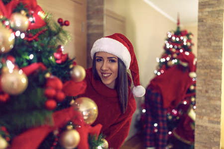 Smiling Girl and decorating beautiful christmas treeの写真素材
