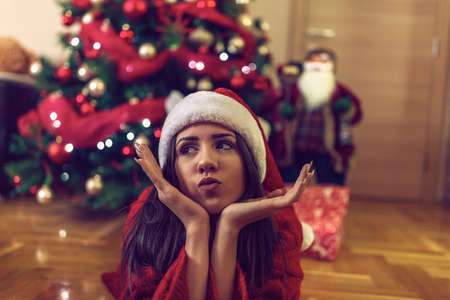 Happy funny girl Santa hats on Christmas celebrating Christmas  at homeの写真素材