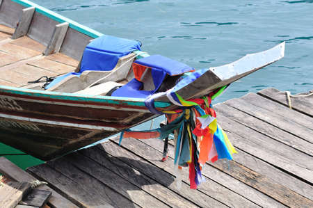 Head of long tailed boat decorated with colorful cloth