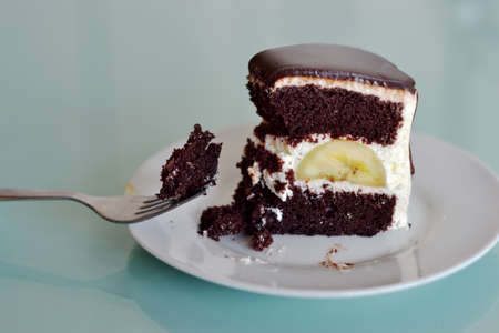 Using a fork, dip chocolate banana cakeの写真素材