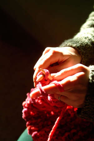 a closeup of a woman's hands knittingの写真素材