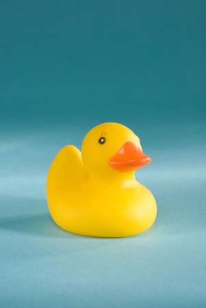 a rubber duck on an aqua blue backgroundの写真素材