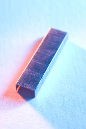 staples on a white seamless background with dramatic lighting