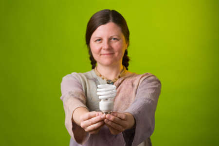 an environmentalist holds a compact fluorescent light bulbの写真素材