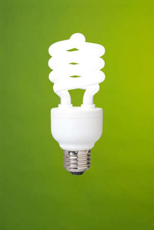 a compact fluorescent light bulb against a green backgroundの写真素材