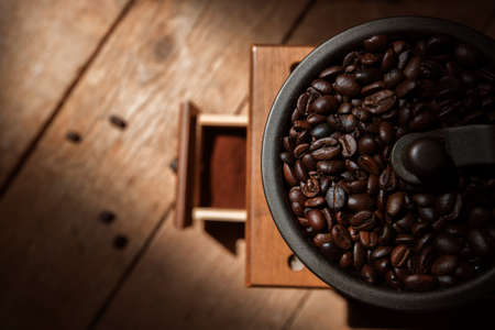 Roasted coffee beans and brown rustic millの写真素材