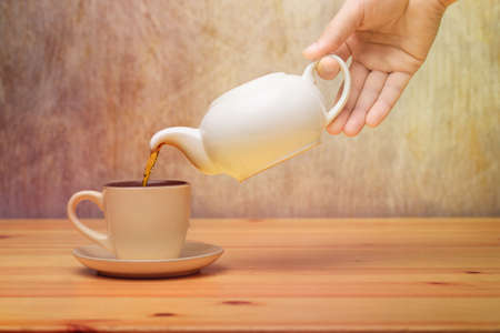 Side view of a male pouring teaの写真素材