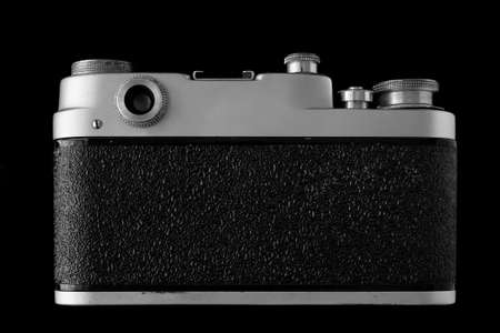 Rear view of retro camera isolated on blackの写真素材