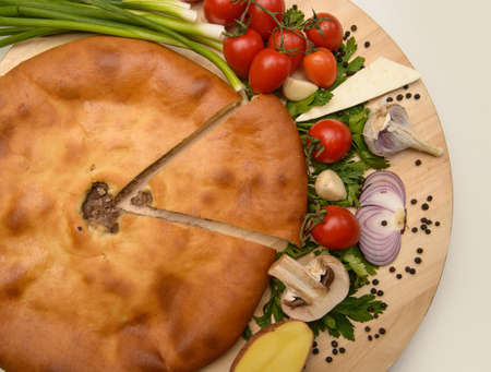 Puff pastry meat pie with vegetables on rustic backgroundの写真素材