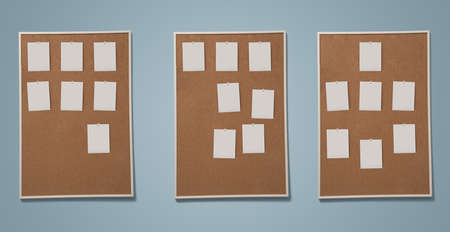 Blank photos pined to frame of cork board on the wall