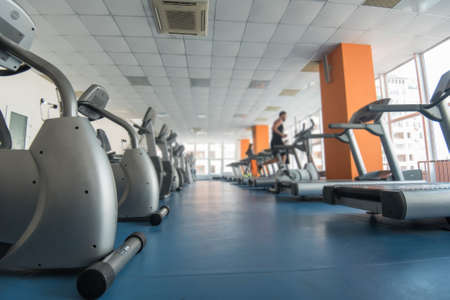 Many treadmills and exercise machines in luxurious modern gym