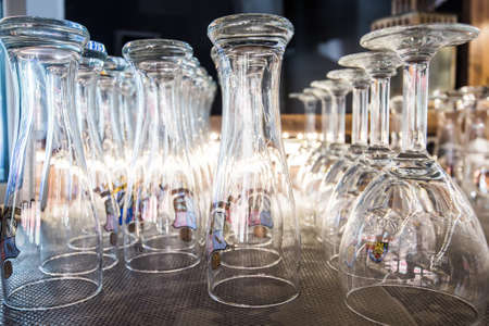Empty glasses on front bar in closed pubの写真素材