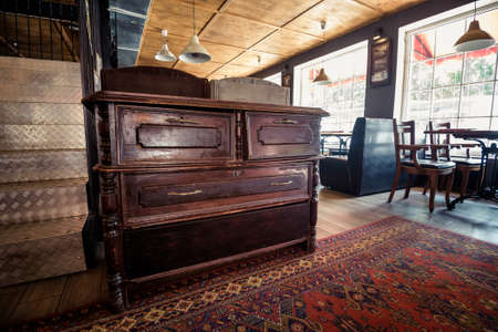 Old vintage wooden chest of drawers in pub interiorの写真素材
