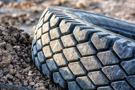 Disposal used car tire lies on the ground