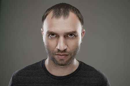 Portrait of hostile unshaven serious caucasian man