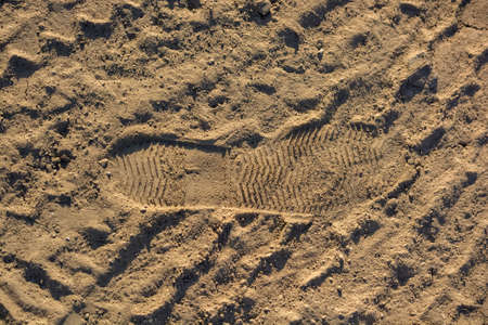 Imprint, footprint of shoe or boot on sandの写真素材