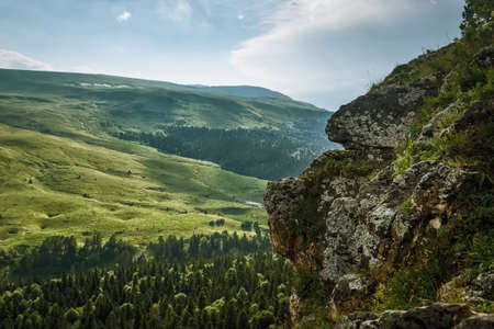 Evening landscape with mountain forest and cloudsの写真素材