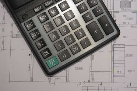 Part of architectural project showing calculator and blueprints