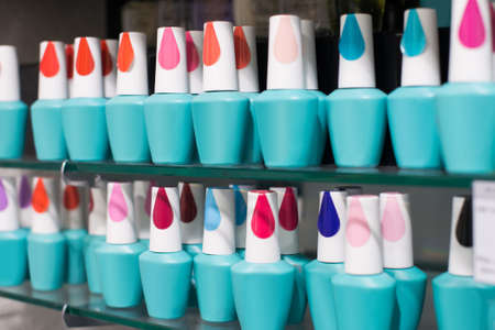 Collection of various nail polish bottle in shelves of a shop in mallの写真素材