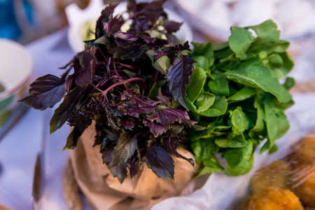 Bunch of purple basil and other herbs on a wooden table