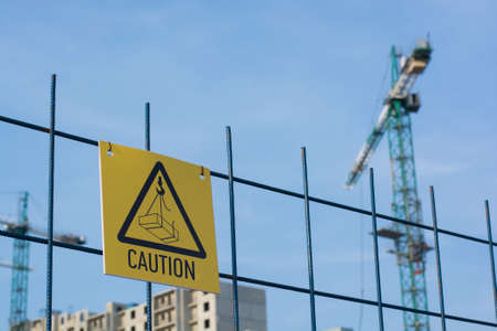 Caution sign at a construction site warns visitors of area Caution sign at a construction site warns visitors of area