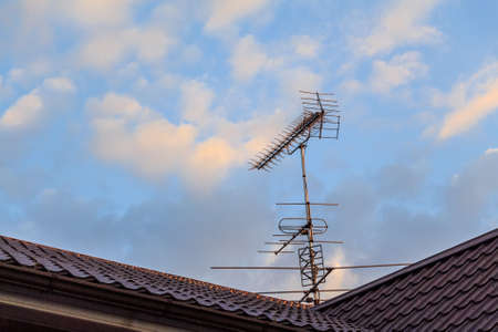 Rooftop television Yagi-Uda antennas on sky background
