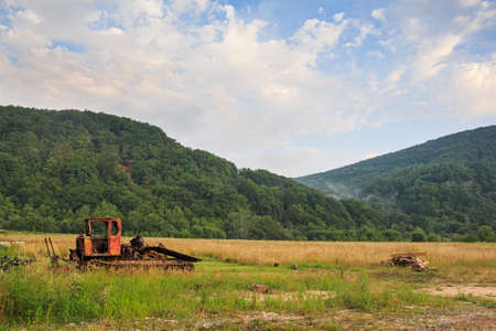 Bulldozer standing on mountain backgroundの写真素材