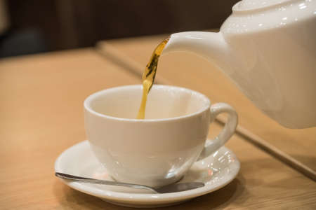 Teapot and cup of tea in cafeの写真素材