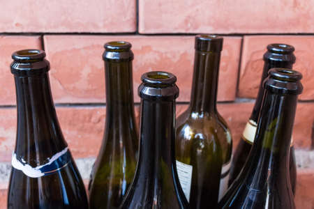 Empty wine bottles symbolizing alcoholism and alcohol addictionの写真素材