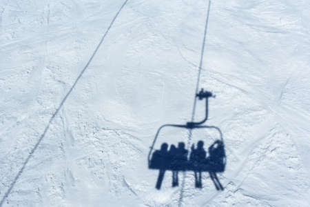 Skiers on a ski liftの写真素材
