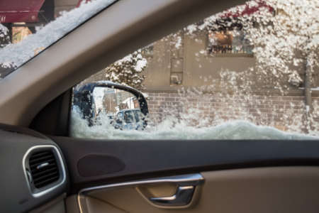 Droplets and snowflakes on car windowの写真素材