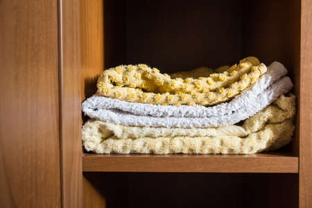 Fragment of a home wardrobe with towelsの写真素材