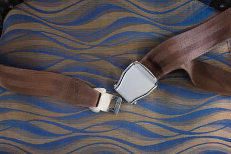 Unfasten safety belt on chair of airplane