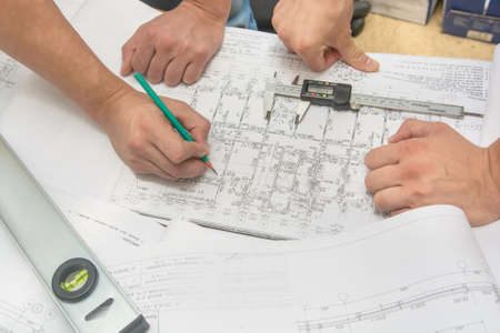 Man holding blueprints at construction site