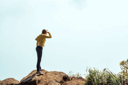 Tourist looking at misty mountainsの写真素材