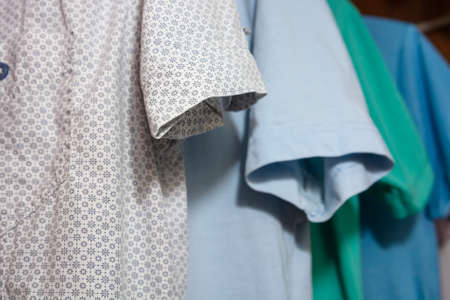 Colorful t-shirts on hangers