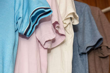 Colorful t-shirts on hangersの写真素材