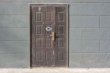 Dirty dark brown entrance door made of steelの写真素材