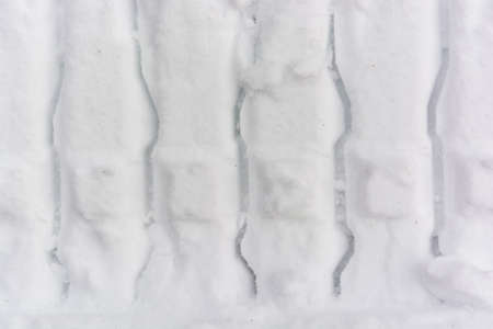 Close up car track in fresh snow background textureの写真素材